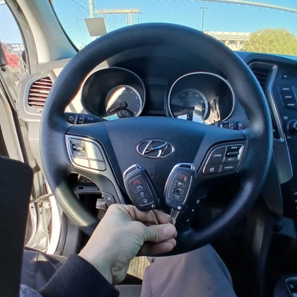 Licensed automotive locksmith technician programming car keys with professional diagnostic equipment at mobile service van in Las Vegas